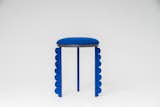 Duality Stool
The Duality stool is a monochromatic three-legged stool upholstered in royal blue colored soft textile, with scalloped edges detailing along the legs.