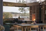 A daybed is built into the corner window, framing a view of the loch.