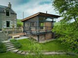 Exterior, Wood Siding Material, Metal Roof Material, Cabin Building Type, Shed RoofLine, and Stone Siding Material The two storey pavilion sits in the garden of a nineteenth century former schoolhouse, now a family home.  Photo 11 of 11 in Rescobie Pavilion by Kris Grant Architect