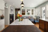 Kitchen, Quartzite Counter, Medium Hardwood Floor, and Wood Cabinet Our transformation opened up the layout, and ushered in a spacious island that beckons culinary creativity and conversation, seamlessly flowing into the dinette area.  Photo 1 of 8 in Spanish Colonial by Quartersawn Design Build