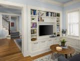 Living Room, Bookcase, and Medium Hardwood Floor The entire main floor received a modern makeover. The exquisite craftsmanship of the cabinetry detail leaves a lasting impression.  Photo 7 of 8 in Spanish Colonial by Quartersawn Design Build