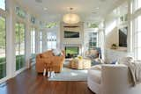 Living Room, Sofa, Pendant Lighting, Dark Hardwood Floor, and Two-Sided Fireplace  Photo 2 of 5 in Artful Addition by Quartersawn Design Build