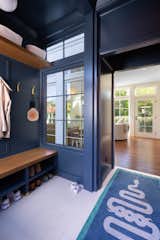 A practical and welcoming mudroom creates a necessary space for the family to pause on their way in the door, adding a layer of convenience to daily life.