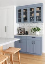 For the coffee bar, we used beautiful hand painted tile from Walker Zanger paired with cabinetry finished in Wolf Gray by Benjamin Moore.