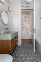 Kids bathroom with a bespoke sink, in the corridor the graphic wallpaper