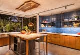 Kitchen, Granite Counter, Wood Cabinet, Ceiling Lighting, and Concrete Floor  Photo 5 of 8 in Conacaste House by Elastica Studio