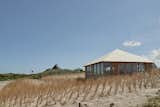 Exterior Asymetrical roof gives the building a different appearance from every angle  Photo 6 of 14 in House in the Dunes by Daan Vulkers
