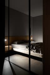 Bedroom, Dark Hardwood Floor, Wardrobe, Wall Lighting, Night Stands, and Bed  Photo 16 of 17 in Hoffman Apartment by Shovk Studio