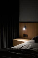 Bedroom, Night Stands, Wall Lighting, Dark Hardwood Floor, and Bed  Photo 11 of 17 in Hoffman Apartment by Shovk Studio