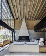 Living Room, Ceiling Lighting, Wood Burning Fireplace, Concrete Floor, Sofa, and Standard Layout Fireplace  Photo 6 of 19 in Noah House by Cadaval Estudio