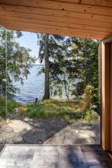 Outdoor, Woodland, Front Yard, Small Pools, Tubs, Shower, Back Yard, Metal Fences, Wall, Hot Tub Pools, Tubs, Shower, Small Patio, Porch, Deck, Trees, and Side Yard View to the lake  Photo 2 of 6 in Lake Sauna by E. Cobb Architects