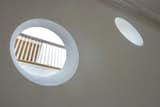 Portals bring light to adjacent spaces from the overhead skylight