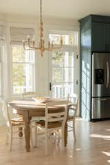 Kitchen, Pendant Lighting, Colorful Cabinet, and Light Hardwood Floor The expandable breakfast table is a nice sunny spot to enjoy morning coffee and a view of the lake.   Photo 3 of 12 in Komorebi House by Andrea Glinn