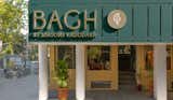 The facade of this store is a sight to behold, clad in yellow particle board. Against this background the branding stands out in a striking contrast of a forest green shade, adding a contemporary twist to the traditional aesthetics along with brushed brass look letters to invoke a rustic essence  Photo 4 of 11 in BAGH by Darshali Golani