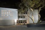 Night view of architecture showing bridge between main house and structure that contains the primary suite