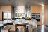 Kitchen, featuring triangular stone and metal  island