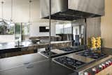 Mirrored kitchen backsplash reflecting architectural view and hearth area