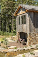 Rustic lodge vibes, dream backyard, private pond, patio, luxury outdoor living space. Natural materials, sustainable, biophilic design.