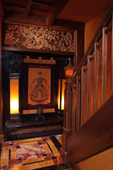 Foyer designed for beautiful art collection. Custom railing with hand-carved lamppost.