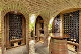 Brick barrel vaulted ceilings, custom light fixtures, wine cellar.