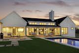 The back of our Sunlit Coastal Ranch has a patio, limited in concrete with grass growing as close to the home as possible in order to feel more natural.