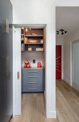 Kitchen, Colorful Cabinet, Wood Cabinet, Ceiling Lighting, Wood Counter, and Vinyl Floor Kitchen Pantry. A view into the new Hallway that leads to the garage, new laundry room, and new powder room.  Photo 7 of 31 in Midcentury Lafayette by Alina Druga Interiors
