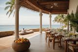 A beachfront restaurant with tables and chairs set up on the sandy shore, offering a picturesque dining experience.