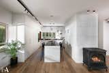 Kitchen, White Cabinet, Wine Cooler, Microwave, Undermount Sink, Dishwasher, Stone Counter, Wood Counter, Medium Hardwood Floor, Marble Counter, Pendant Lighting, Refrigerator, and Marble Backsplashe  Photo 8 of 37 in The Gordon's house by HILA ALTER
