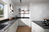 Kitchen, Undermount Sink, White Cabinet, Wood Cabinet, Marble Backsplashe, Medium Hardwood Floor, Stone Counter, Marble Counter, and Pendant Lighting  Photo 10 of 37 in The Gordon's house by HILA ALTER