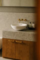 The LUNA Marbleform basin by Claybrook, supplied by Arnhold HK, sits atop a custom made bathroom vanity. 