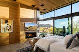 Bedroom, Chair, Concrete Floor, and Bed Primary bedroom with wood paneled walls and corner pocket stacked sliding glass doors.  Photo 8 of 15 in Big Girl House by Tate Studio Architects