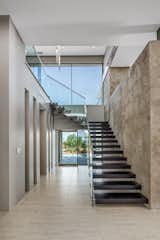 Staircase, Glass Railing, and Metal Railing Sculptural, open tread staircase.  Photo 8 of 16 in Minimalist Impact by Tate Studio Architects
