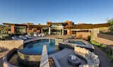 Outdoor, Large Patio, Porch, Deck, Concrete Patio, Porch, Deck, Back Yard, Large Pools, Tubs, Shower, Infinity Pools, Tubs, Shower, Hardscapes, and Desert Overall back exterior pool view.  Photo 2 of 18 in Curve Appeal by Tate Studio Architects