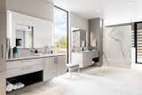 Primary bathroom with dual vanities separated by a floor-to-ceiling window.