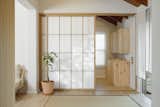 SHOJI solid wood sliding door separates the foyer from the playroom
