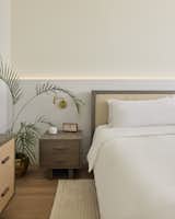 Linear light built in behind the bed keeps the vibe of the master suite warm and comfortable.