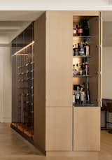 Up close view of the hidden bar caps off incredible wine storage center piece to the open floor plan kitchen.