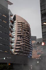 Exterior, Curved RoofLine, and Apartment Building Type Exterior View of Carbon Condominium in Urban Environment  Photo 12 of 13 in Carbon Nexus: Futuristic Living in Composite Carbon by Ziyu Xu