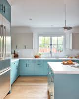 Open and light filled, this teal and grey kitchen is the perfect family gathering place featuring a big functional island to allow for many cooks in the kitchen. 