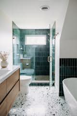 Bath Room, Wall Lighting, Terrazzo Floor, Freestanding Tub, Undermount Sink, Recessed Lighting, Two Piece Toilet, Porcelain Tile Wall, Engineered Quartz Counter, and Enclosed Shower  Photo 7 of 13 in Clean lines with a retro spin by Jill Lamphier