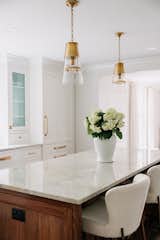 Kitchen, White Cabinet, Refrigerator, Accent Lighting, and Quartzite Counter A Kitchen Island Dreams are made of  Photo 10 of 12 in Exquisite Kitchen Renovation by Jill Lamphier