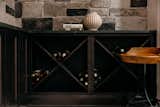 Wine Cellar with Custom Cabinetry and Stone Walls 