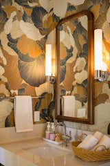 Powder bathroom with wallpaper.