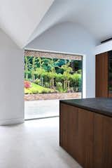 Cooking with a view: South-facing garden charm captured through a picture window in the kitchen.