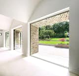 Indoor and outdoor spaces blend together as large glazing frames the South-facing landscaped garden. Brick soffits and splayed piers provide protection from the changeable Dublin weather