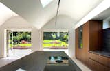 Sculpted curved ceilings float above built in kitchen units