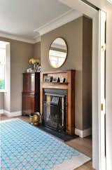 The original fireplace, meticulously refurbished and preserved in the front Sitting Room, stands as a timeless testament to the home's history. Against muted backdrop tones, colourful accents come alive, creating a harmonious interplay of old and new.