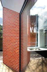 Brick piers extend out from large glazed sliders, allowing protection from the ever-changing weather in Dublin.