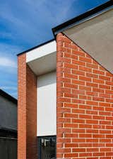 Exterior, Brick Siding Material, Stucco Siding Material, Metal Roof Material, House Building Type, and Flat RoofLine The carefully selected red brick are contrasted against the smooth plaster finish, showcasing its natural variation. Special bullnose bricks shape deep splayed reveals.  Photo 10 of 24 in 1930s Extension & Refurbishment by David Flynn Architects Ltd