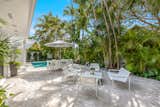 Outdoor, Trees, Concrete Fences, Wall, Vertical Fences, Wall, Swimming Pools, Tubs, Shower, Large Patio, Porch, Deck, Back Yard, and Landscape Lighting  Photo 3 of 7 in Key West Midcentury Stunner by Team Kaufelt